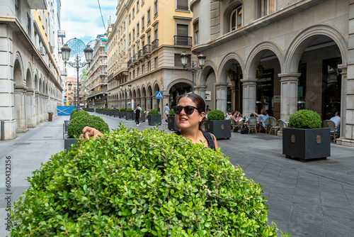 empleada de un hotel, cuidando las plantas en una centrica ciudad de Europa photo