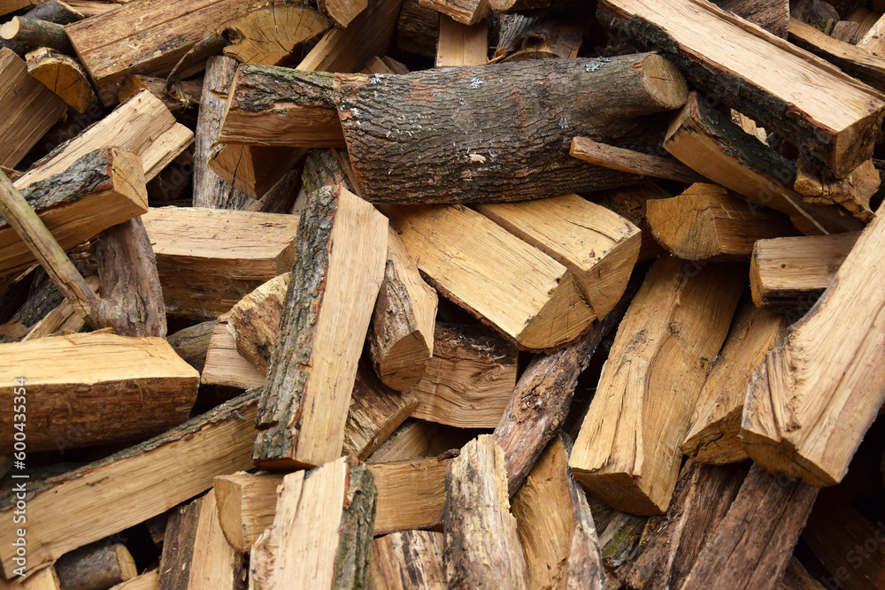 Lots of chopped oak firewood. Natural background. Lots of chopped oak firewood. Natural background.
