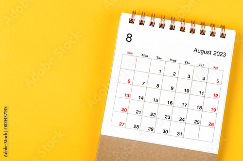 A August 2023 Monthly desk calendar for 2023 year on yellow background. photo