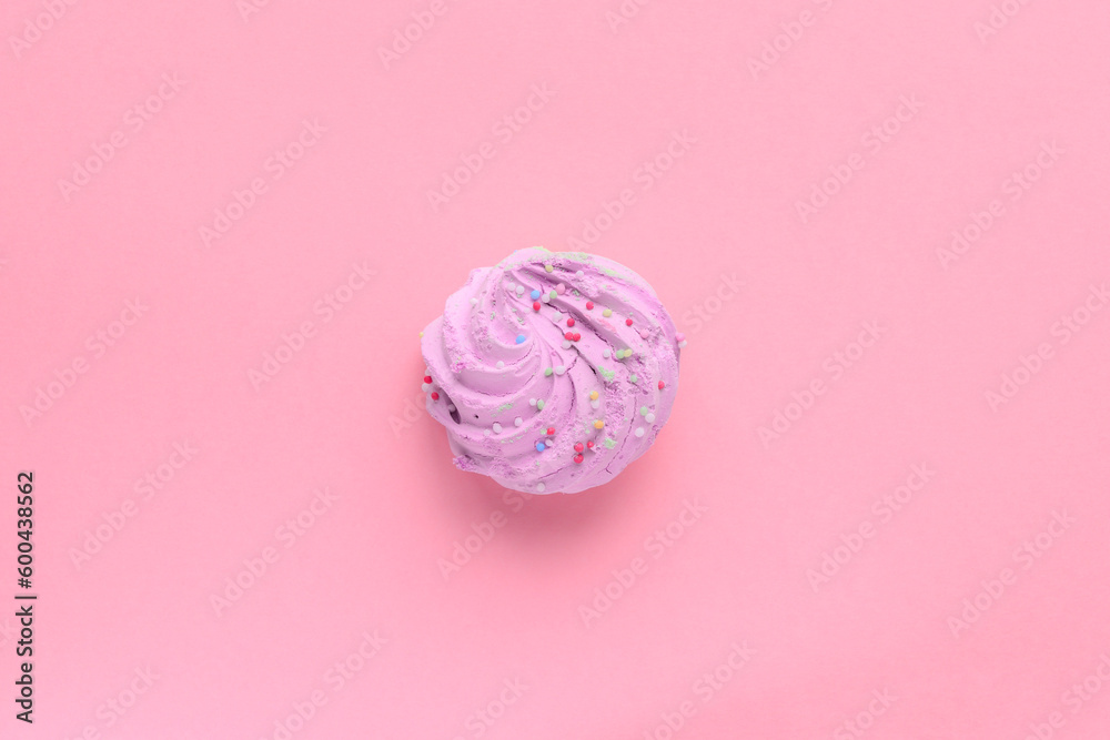 Single delicious purple meringues on pink background copy space Single delicious purple meringues on pink background copy space