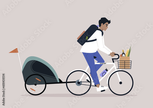 A young Caucasian parent riding a bike with a  kid trailer
