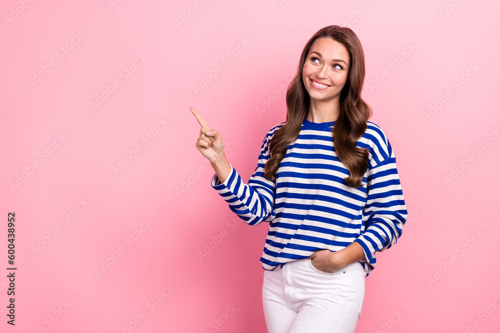 Photo of positive cheerful woman wavy hairdo dressed striped shirt look directing at sale empty space isolated on pink color background Photo of positive cheerful woman wavy hairdo dressed striped shirt look directing at sale empty space isolated on pink color background
