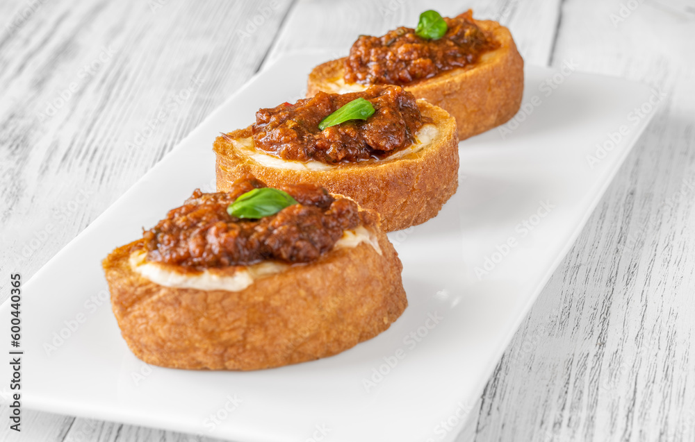 Ciabatta bruschettas with mozzarella and puttanesca Ciabatta bruschettas with mozzarella and puttanesca