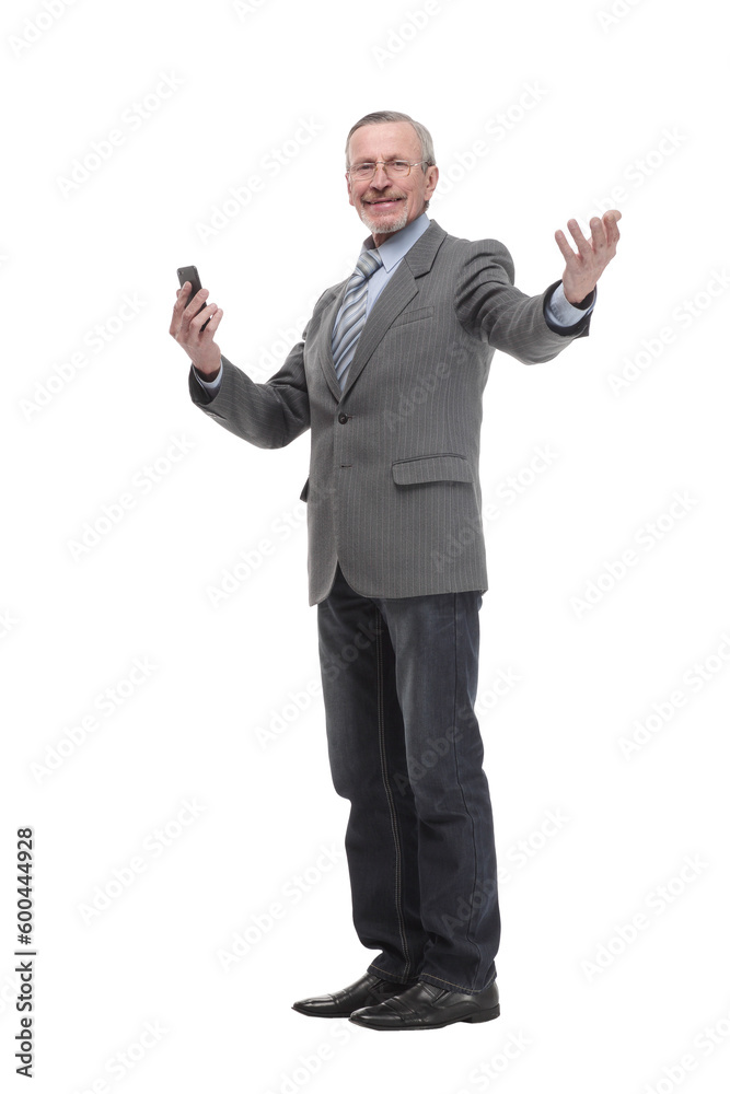 Portrait of a happy mature man dressed in suit holding mobile phone and looking at camera Portrait of a happy mature man dressed in suit holding mobile phone and looking at camera