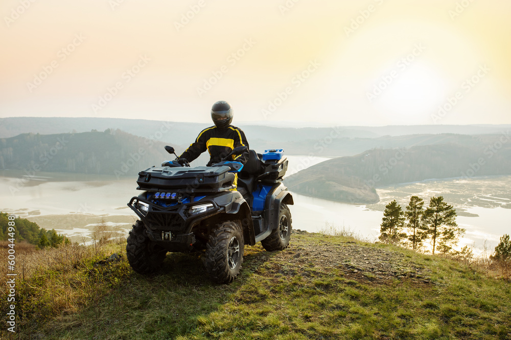 man riding atv vehicle on off road track in mountains. adventure active journey atv in mountains. man riding atv vehicle on off road track in mountains. adventure active journey atv in mountains.