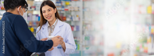 consulting, Medicine imformation, Asian female pharmacists explaining how to take drugs to treat diseases correctly at Pharmacy Drugstore.  Health and wellness center photo