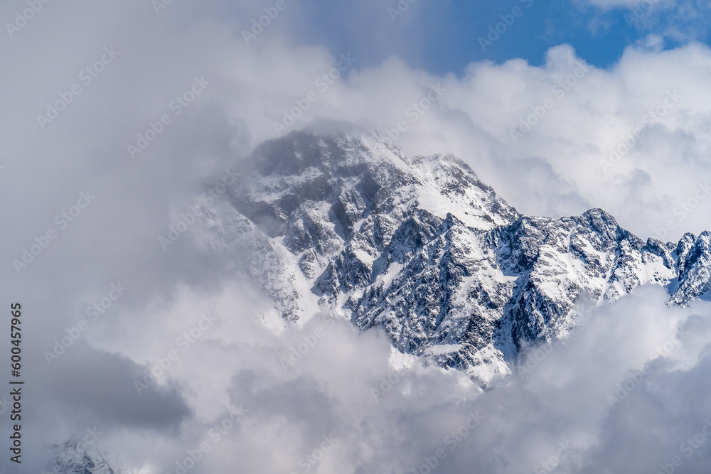 Mountain peak in clouds. Top of snowy rock in Georgia. Mountain peak in clouds. Top of snowy rock in Georgia.