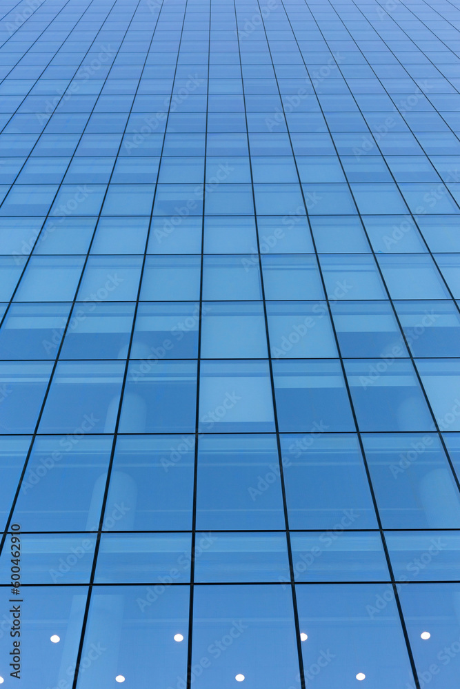 Blue sky reflecting in windows of modern office building