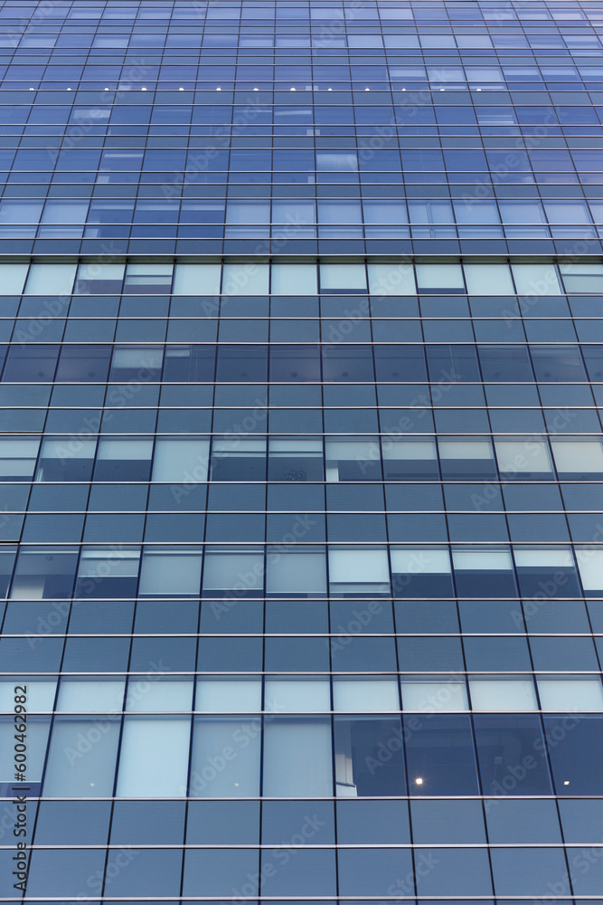 Blue sky reflecting in windows of modern office building Blue sky reflecting in windows of modern office building