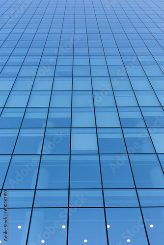 Blue sky reflecting in windows of modern office building