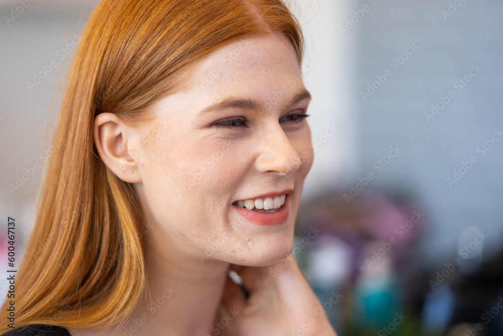 Fototapeta premium Portrait of beautiful redhead female smiling. Closeup woman face