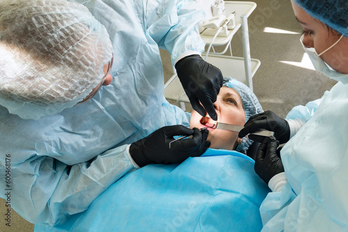 Surgeon and nurse during dental operation