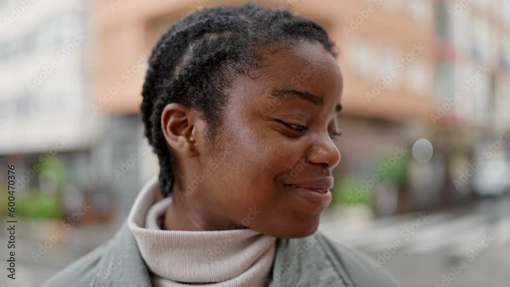 African american woman smiling confident looking to the side at street