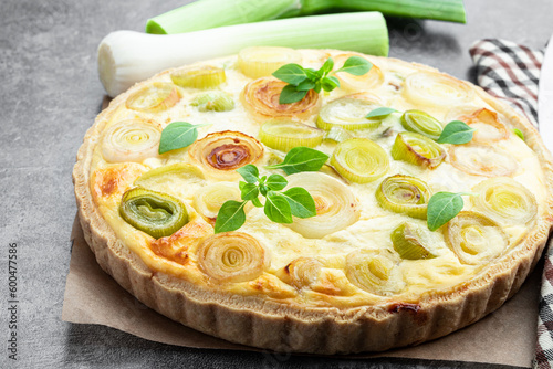 Quiche with leek and cheese on gray background photo
