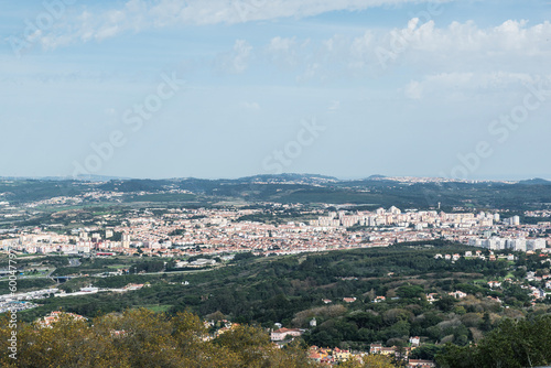 Aerial view of Sintra in Portugal. Old city seen from a distance. Landscape with buildings and woods © Renata