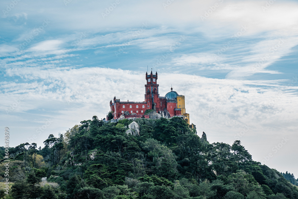 National Pena Palace in Sintra, Portugal. View of hill cover with trees with Palace on top National Pena Palace in Sintra, Portugal. View of hill cover with trees with Palace on top