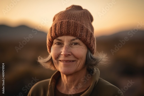 Portrait of a senior woman in a knitted hat in the mountains