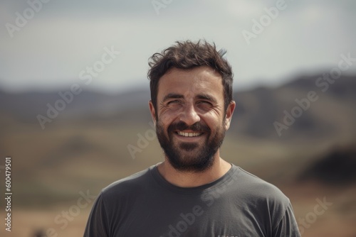 Portrait of a handsome young man with beard and mustache in the desert
