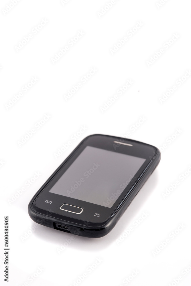 Old black mobile phone isolated on white background. Focus on the screen. Old black mobile phone isolated on white background. Focus on the screen.