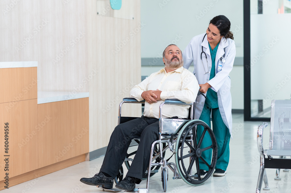 Young woman doctor with senior man sitting on wheelchair in hospital. female doctor assist take care of smiling old man. elderly healthcare concept.