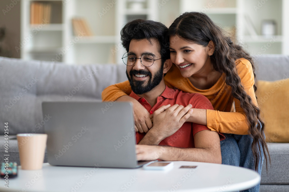 Portrait Of Romantic Indian Couple Using Laptop Together At Home Portrait Of Romantic Indian Couple Using Laptop Together At Home