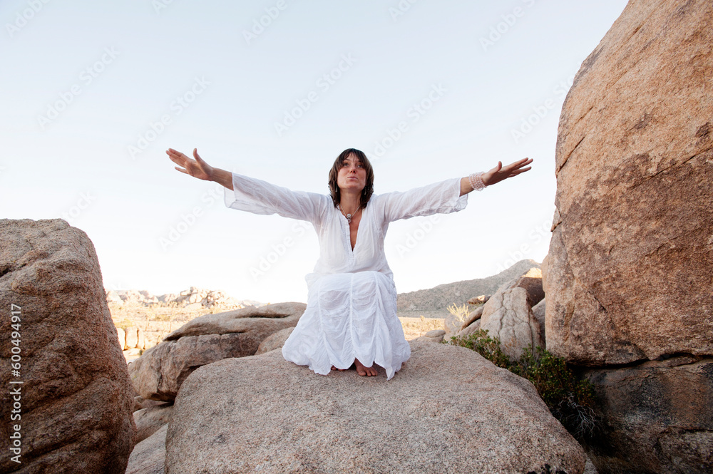 Spiritual woman meditating and chanting in the desert of Joshua Tree. Spiritual woman meditating and chanting in the desert of Joshua Tree.