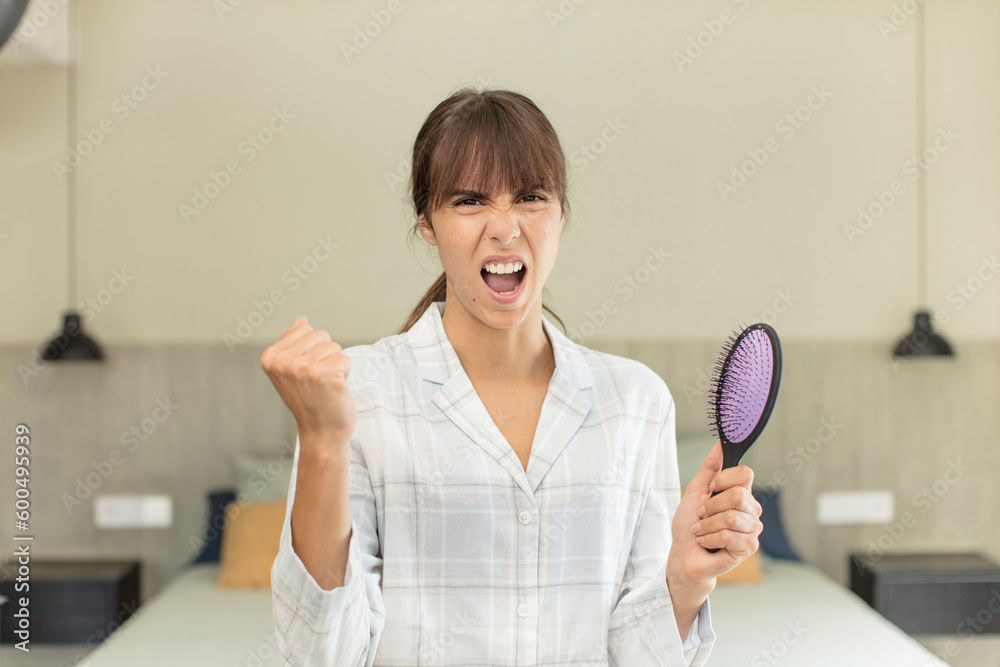young pretty woman looking angry, annoyed and frustrated. hair comb concept young pretty woman looking angry, annoyed and frustrated. hair comb concept