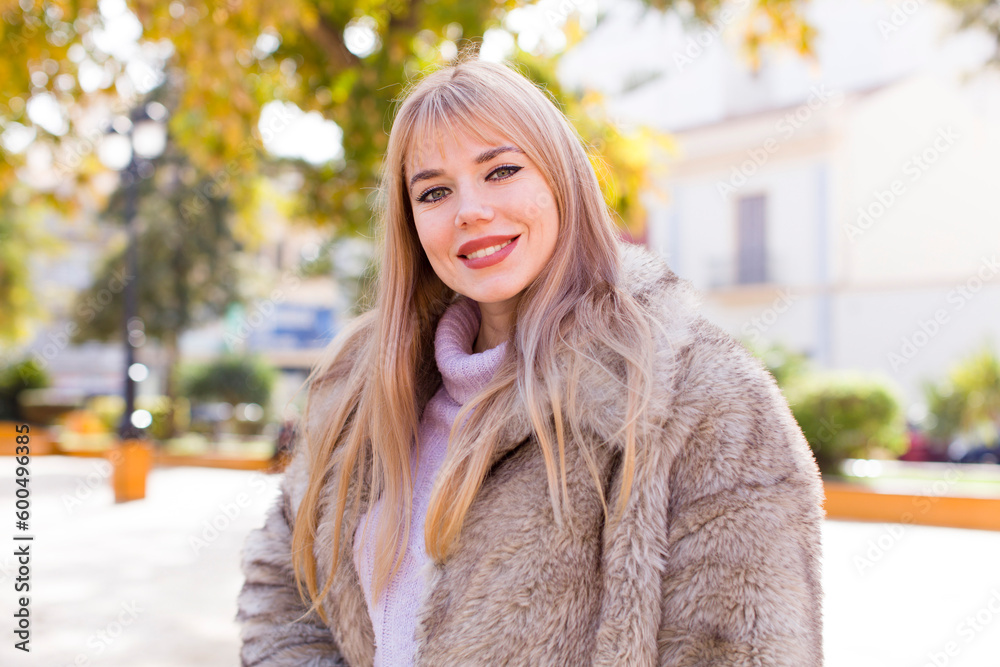young pretty woman smiling happily with a hand on hip and confident, positive, proud and friendly attitude young pretty woman smiling happily with a hand on hip and confident, positive, proud and friendly attitude