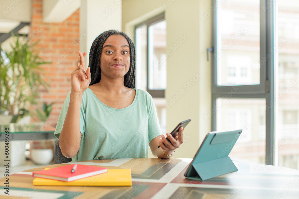 black afro woman crossing fingers and hoping for good luck. studying concept black afro woman crossing fingers and hoping for good luck. studying concept