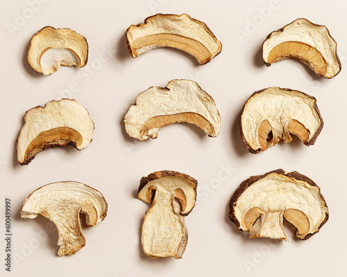 Set of dried slices of porcini on beige background, dehydrated food boletus mushrooms, top view, flatlay. Gourmet food ingredient, vegetable protein wild forest white mushroom, healthy eating