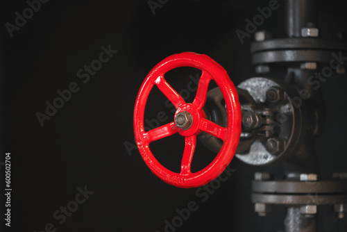 Red gate valve of the pipeline close up background with copy space.