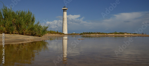 Lighthouse reflected in the water, salt marsh of Jandia, coast of Fuerteventura, Canary Islands, Spain © ptoscano
