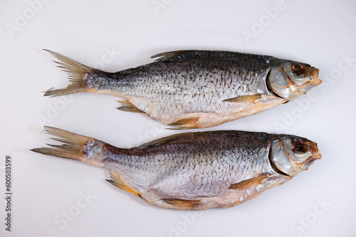 Dried salted river fish on a white background. Traditional snack for beer.