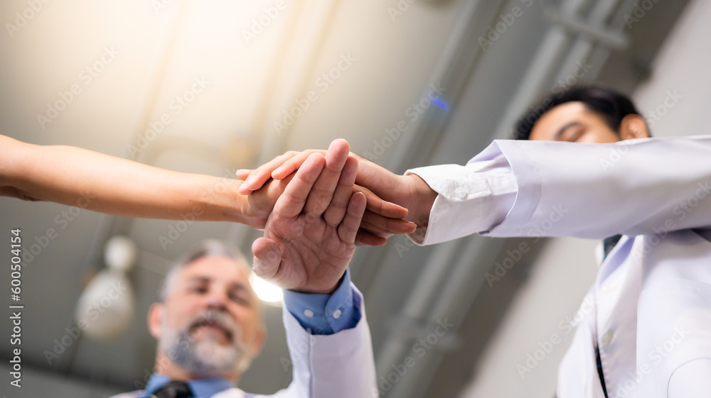 Diverse doctor and nurse stack hands together at hospital medical wellness center. Professional medical staff people successful and teamwork concept Diverse doctor and nurse stack hands together at hospital medical wellness center. Professional medical staff people successful and teamwork concept
