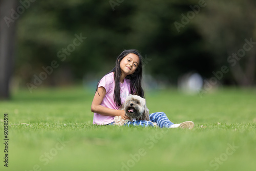 child playing with their dog in the park 
