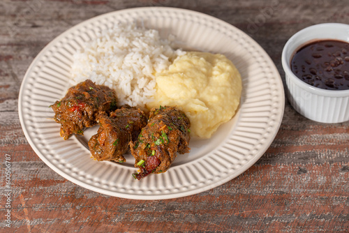 Beef rolls in delicious tomato sauce , served with rice and mashed potatoes. . Brazilian 