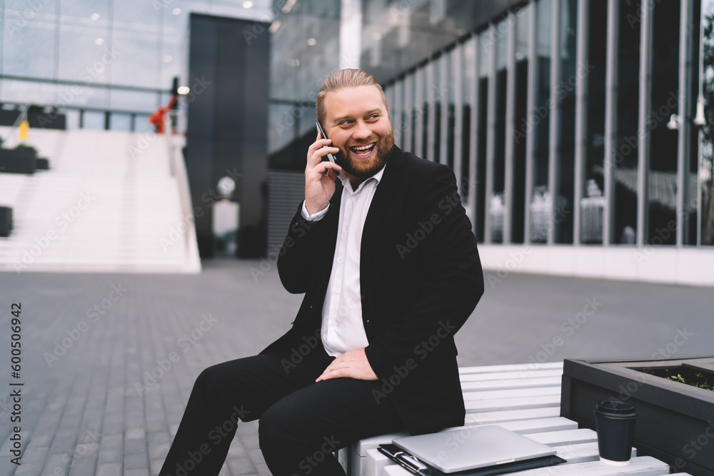 Cheerful businessman talking on smartphone Cheerful businessman talking on smartphone