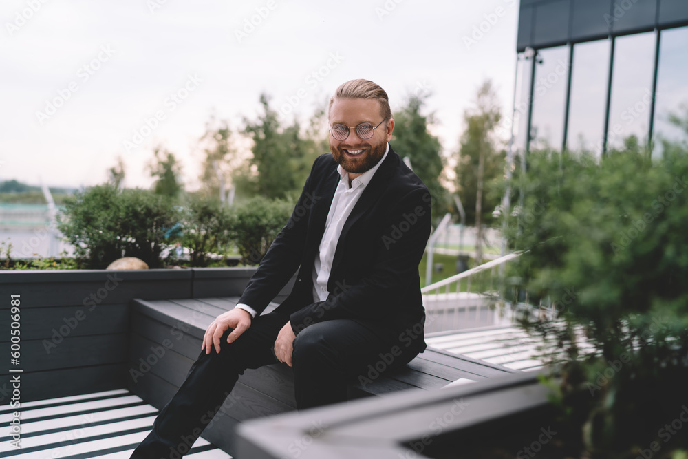 Happy man in suit sitting on bench Happy man in suit sitting on bench