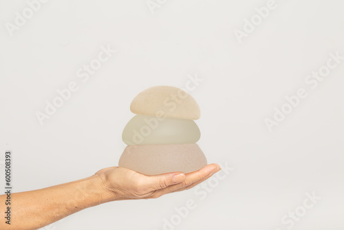 Woman holding silicone implants for breast augmentation , space for text. cosmetic surgery