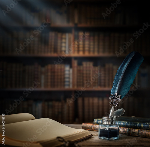 Old quill pen with an inkwell, papers and books on a table against an old bookshelf. Concept on the theme of history, education, literature. Retro style.