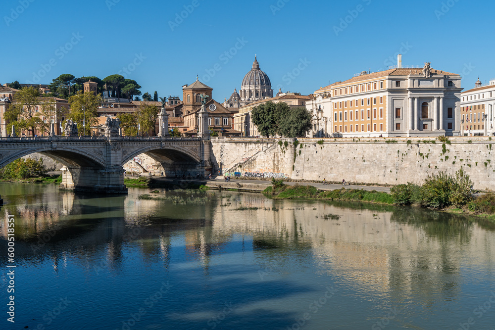 Beautiful cityscape of Rome in a sunny day, with the Tiber River and the famous St. Peter Basilica, Italy