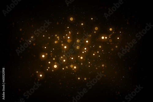 Abstract defocused lights and bokeh on dark background. Gold sparkles and glitter on black background