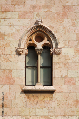 castle's window with column and sculptures