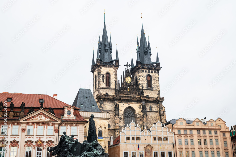 Low-angle view of the Church of Our Lady before Tyn in Prague against a cloudy sky.
