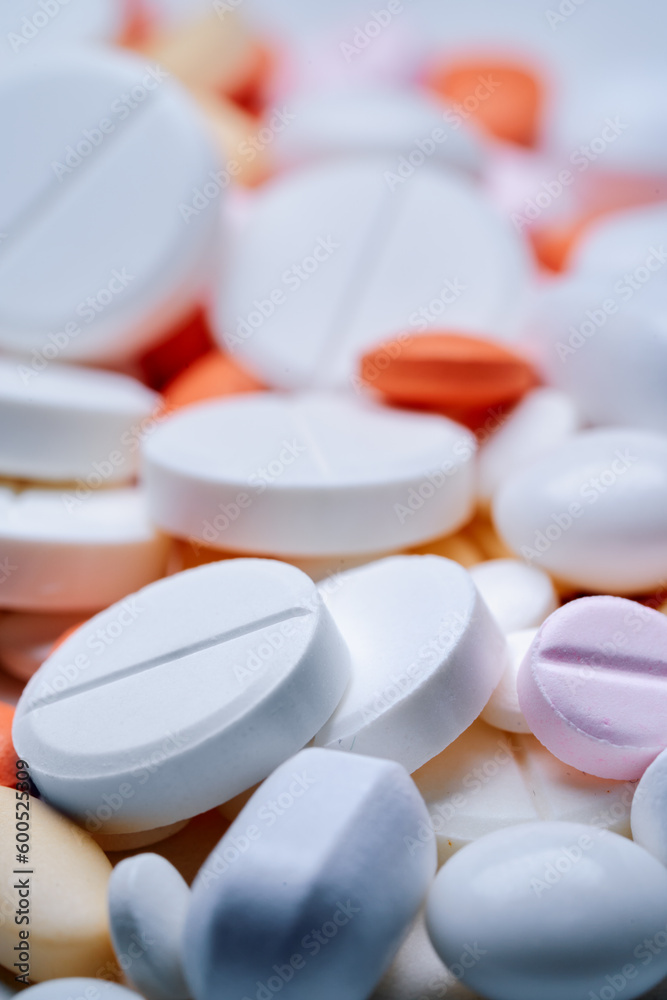 Medicine and drug concept. Close up shot of white and colored pills of different kinds. Medicine and drug concept. Close up shot of white and colored pills of different kinds.