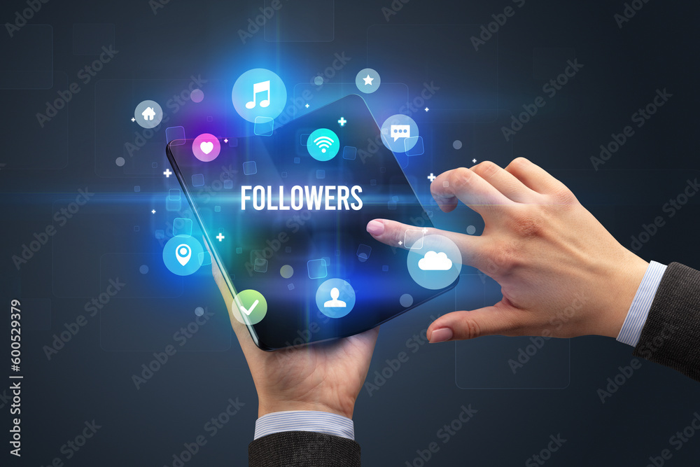 Businessman holding a foldable smartphone Businessman holding a foldable smartphone