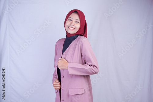 An Asian woman is showing the expression with pink dress and coat.
