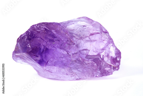 Amethyst. A raw amethyst nugget on a white background. Amethyst is a variety of quartz. Amethyst is purple in color. It is a semi-precious stone.