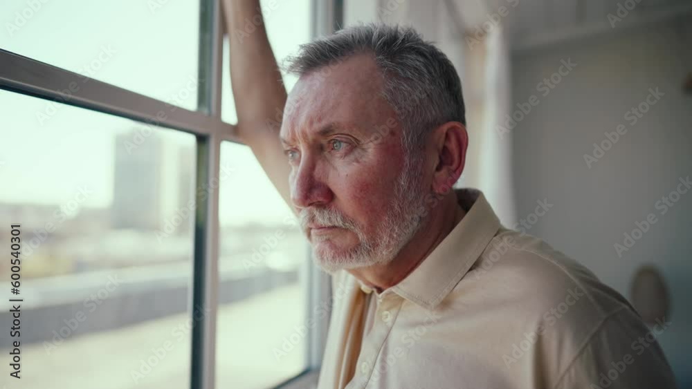 Close up sad elderly man face looking out the window, yearning about past recollect memories. Sad old man crying near window, suffering loneliness, emotions, feelings and spending time at home. Close up sad elderly man face looking out the window, yearning about past recollect memories. Sad old man crying near window, suffering loneliness, emotions, feelings and spending time at home.