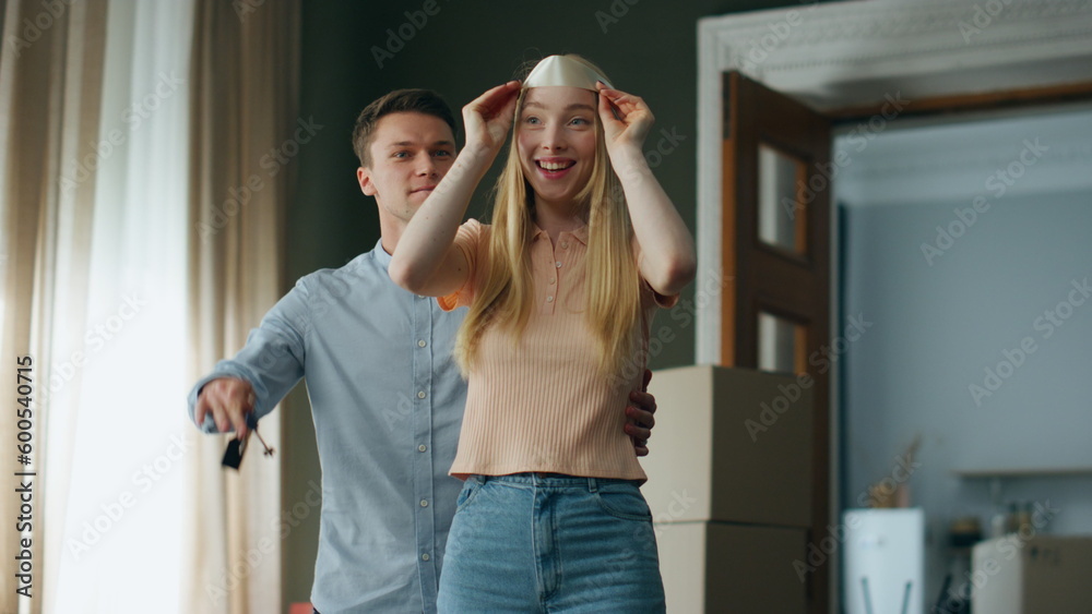 Man surprising woman showing keys from new apartment. Girl rejoicing moving home Man surprising woman showing keys from new apartment. Girl rejoicing moving home
